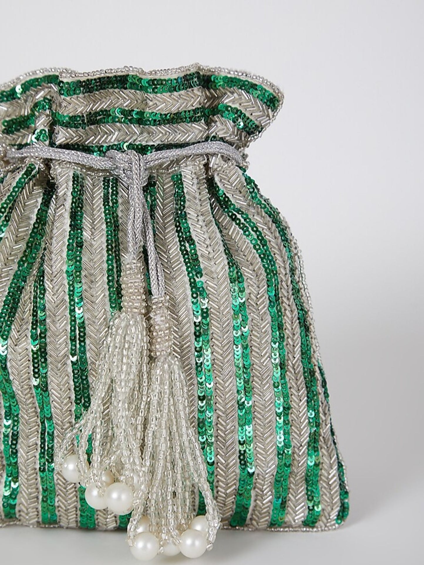 Green sequined hand-embroidered potli bag with intricate detailing, perfect for festive occasions and traditional events.