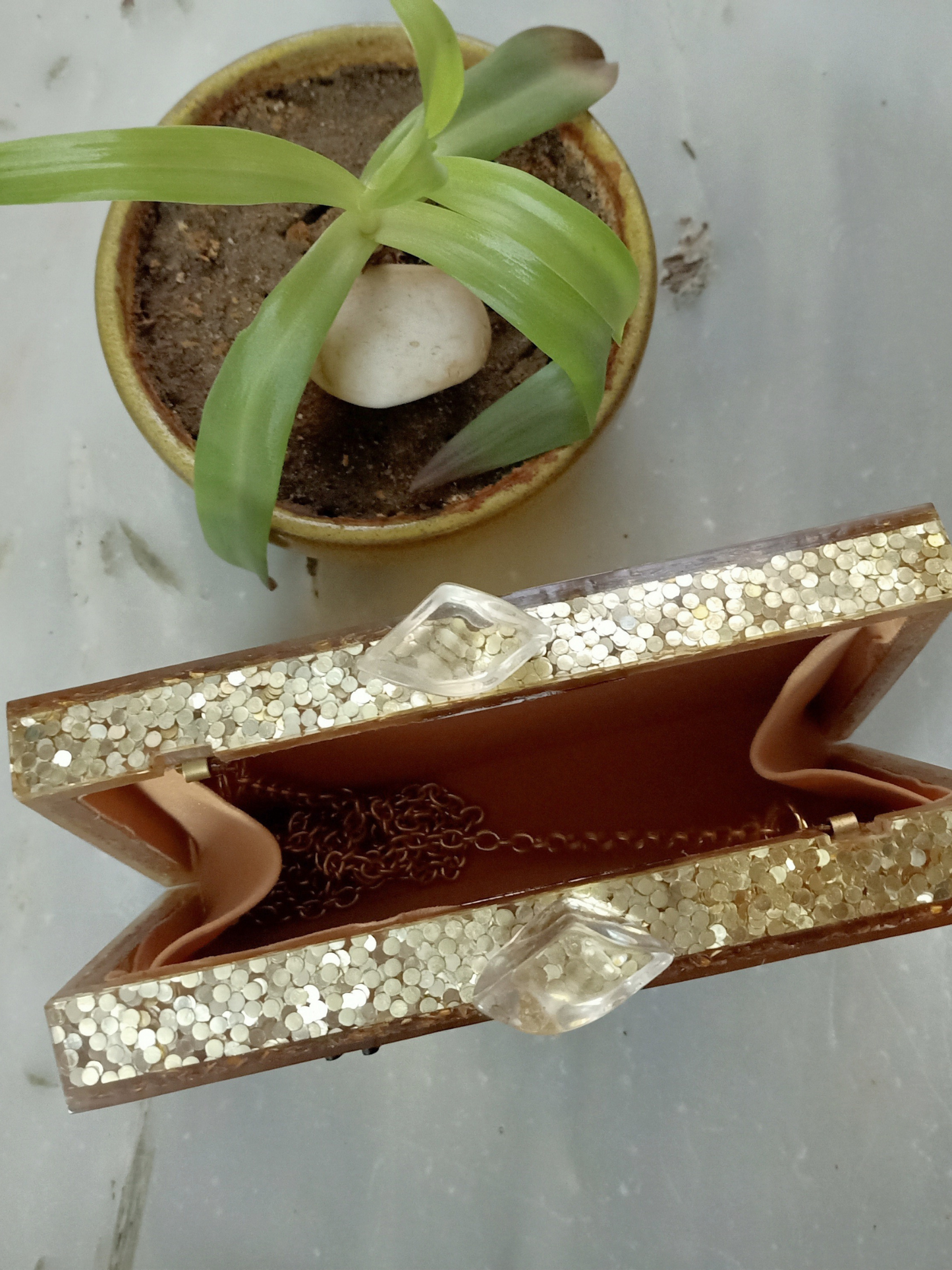 Gold glitter embossed customized clutch bag with textured surface and sleek design, perfect for elegant occasions.