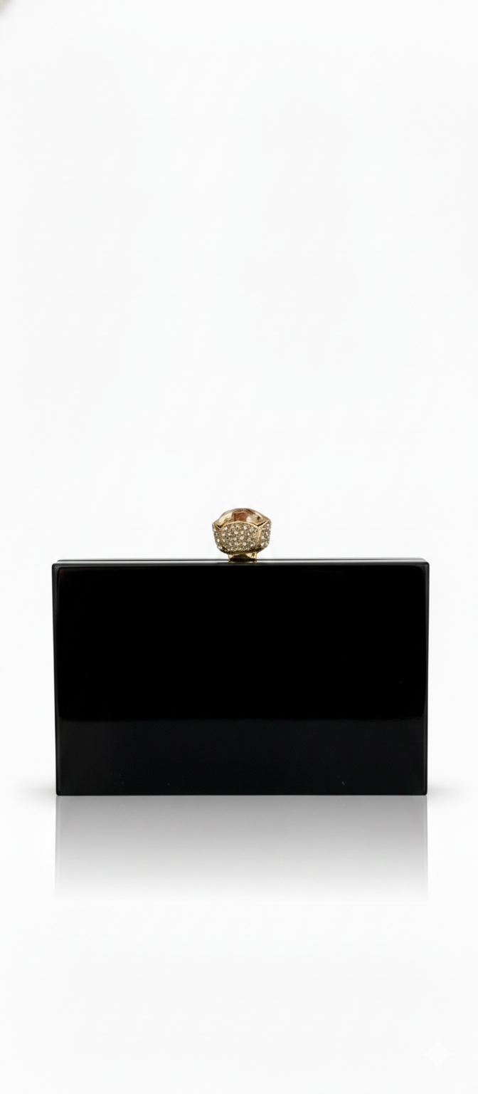 Black Midnight Aura clutch bag by aclutchstory featuring a sleek, elegant design with a textured finish and silver clasp detail.