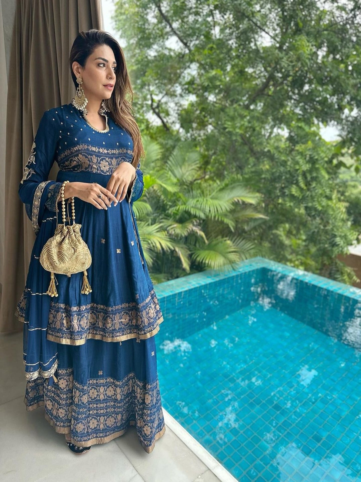 Antique gold Matka potli bag from aclutchstory worn by Anjum Fakih, featuring intricate design and traditional Indian craftsmanship.