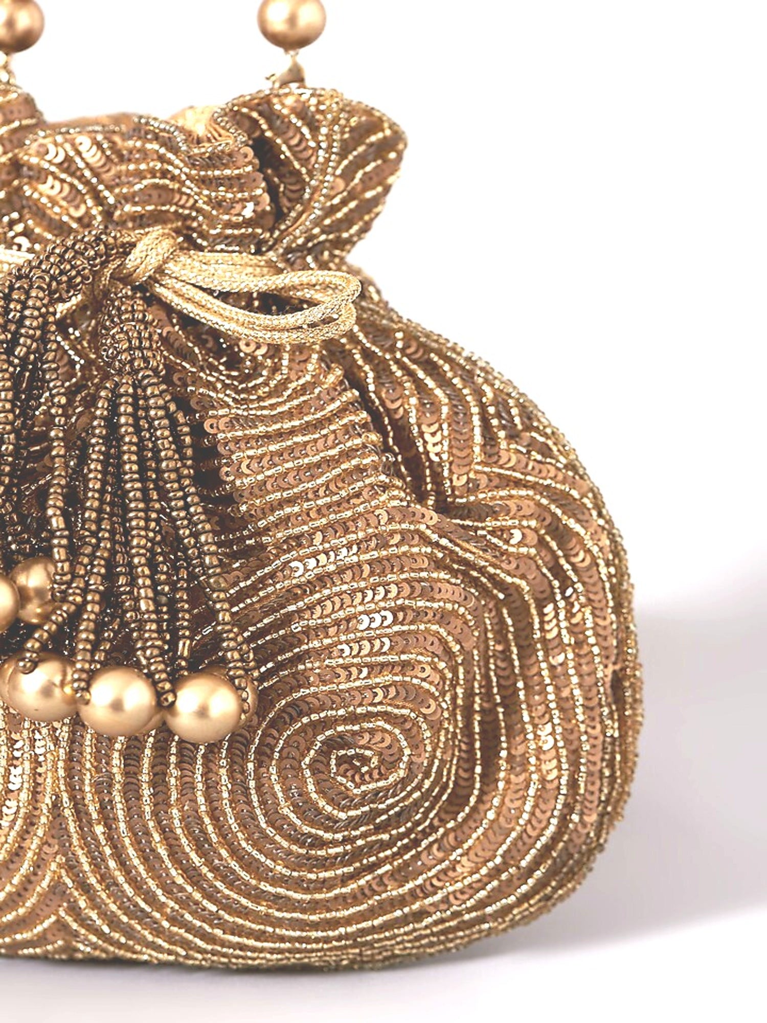 Antique gold matka potli bag by aclutchstory, featuring intricate design, seen on Anjum Fakih, traditional Indian accessory.