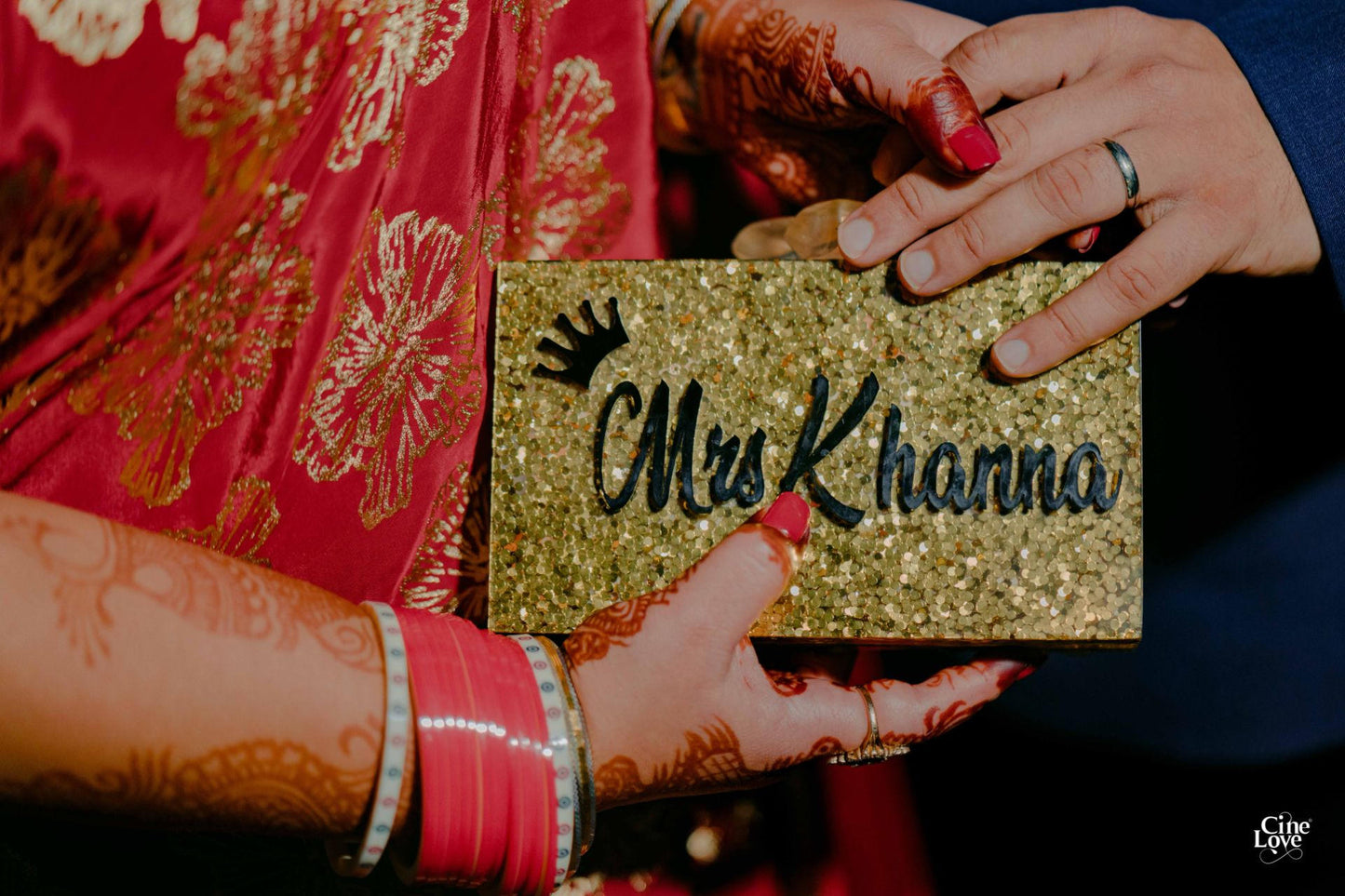 Gold glitter embossed customized clutch bag by aclutchstory, featuring a shimmering surface and elegant design.