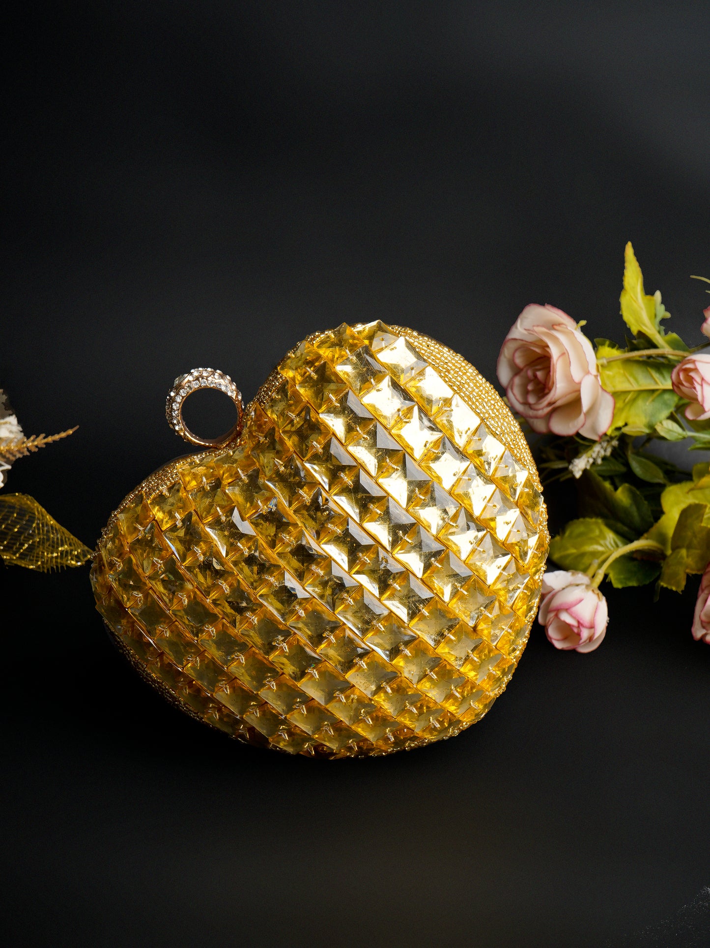 Citrine heart-shaped clutch bag with gold clasp, featuring a vibrant yellow gemstone design for stylish evening wear.