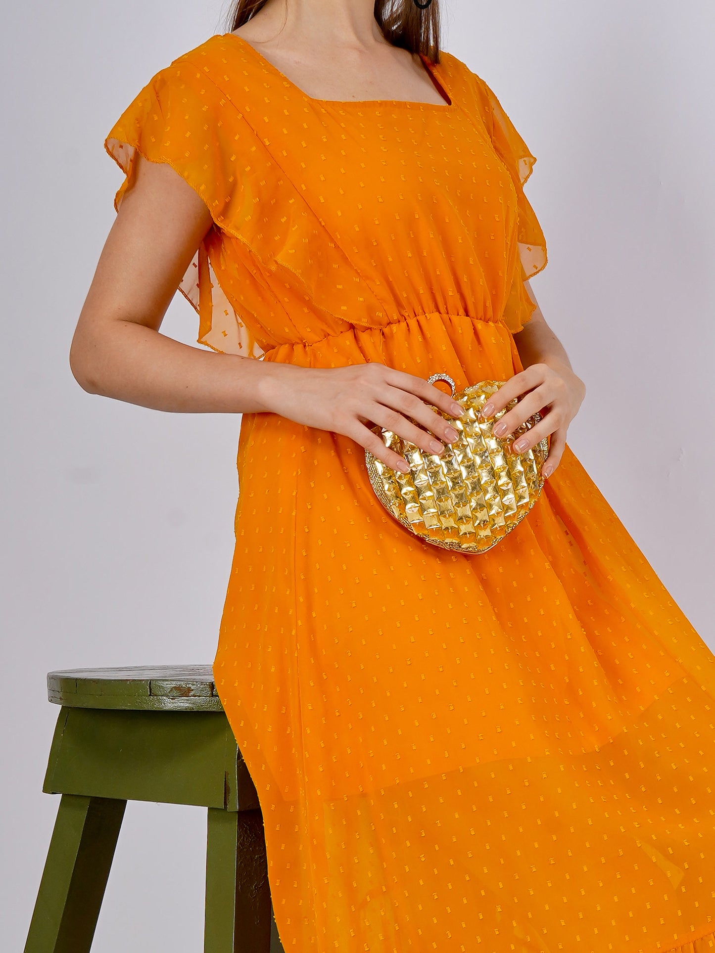 Citrine heart-shaped clutch bag with gold-tone clasp from aclutchstory, showcasing a glossy, vibrant gemstone-inspired design.