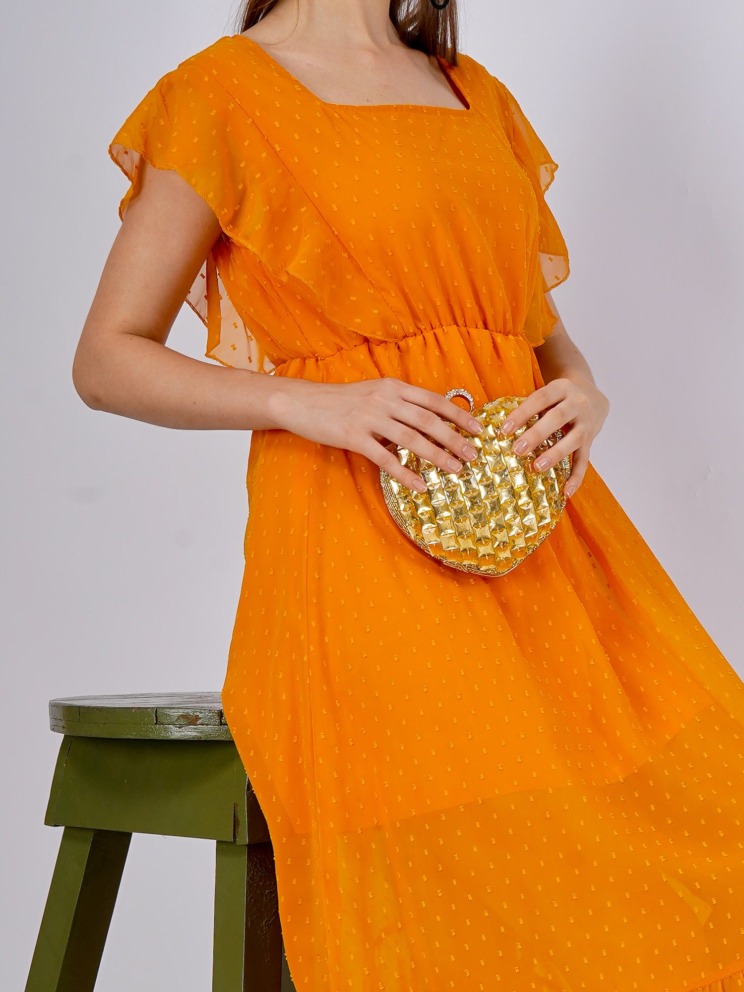 Citrine heart-shaped clutch bag with gold-tone clasp from aclutchstory, showcasing a glossy, vibrant gemstone-inspired design.