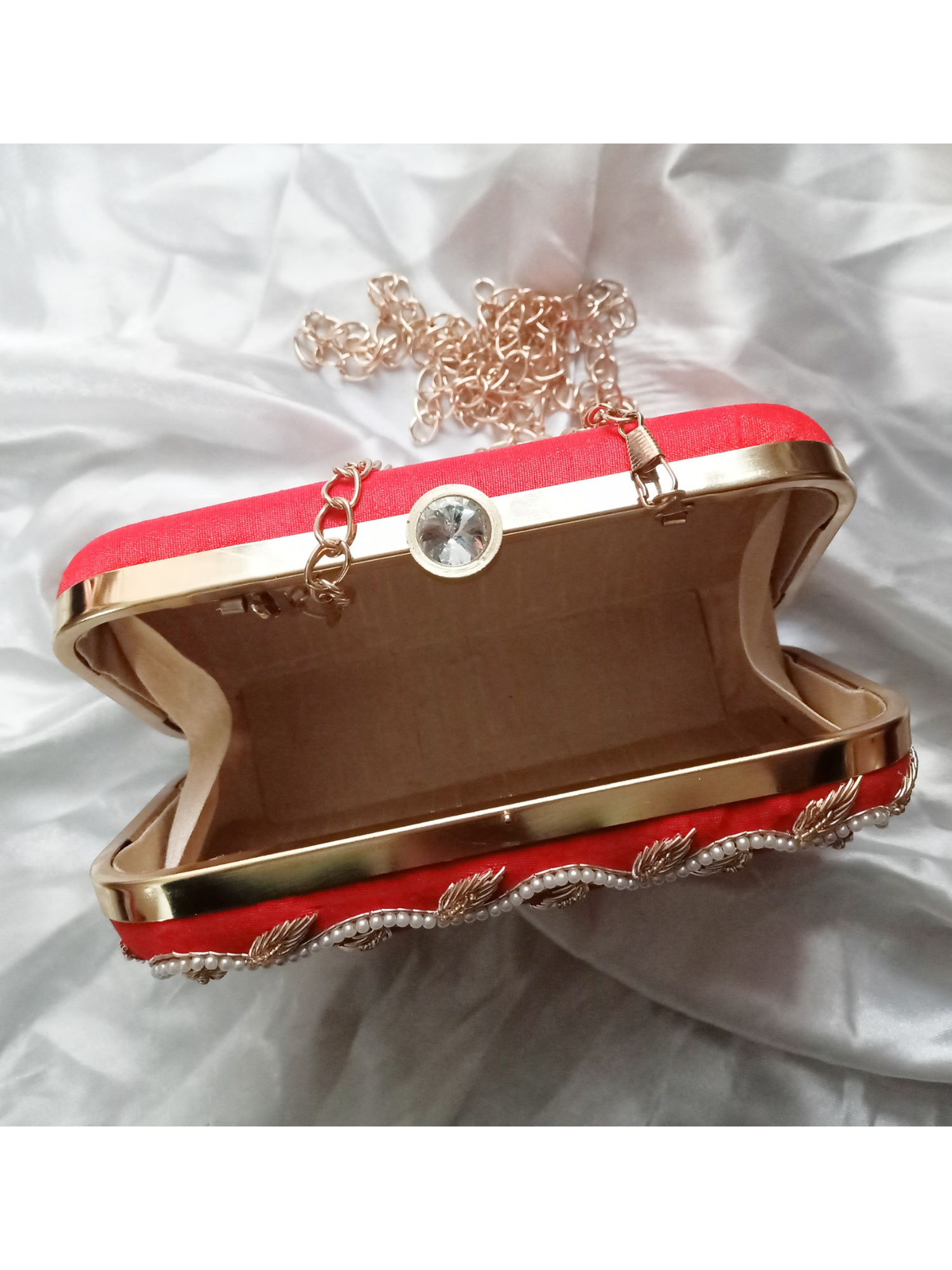 Red Dabka leaf clutch bag with intricate embroidery, handcrafted by aclutchstory, featuring a stylish and unique design.