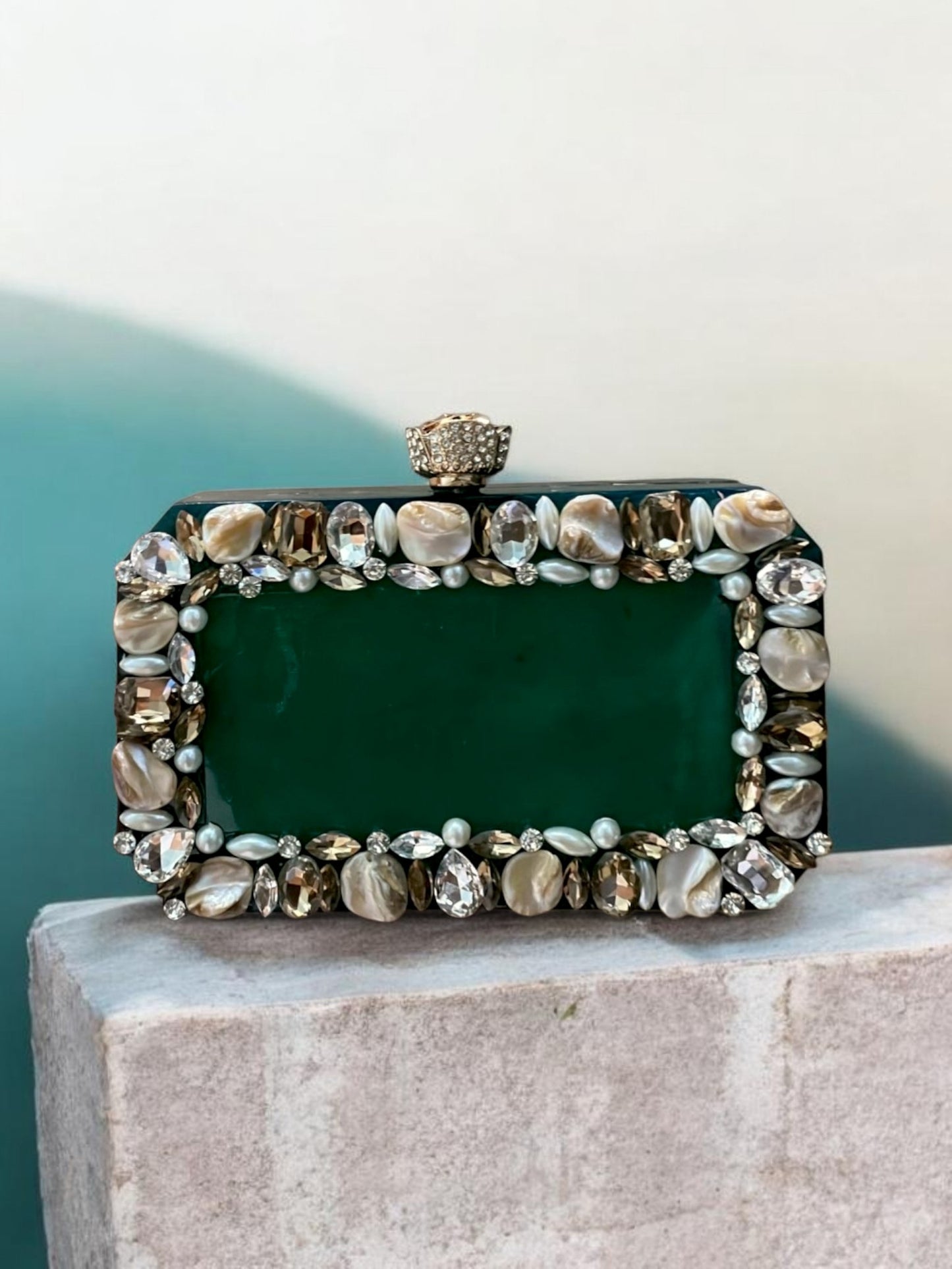 Emerald Aura Resin clutch bag by aclutchstory featuring a vibrant green color. Comes with beautiful stone work on all sides.
