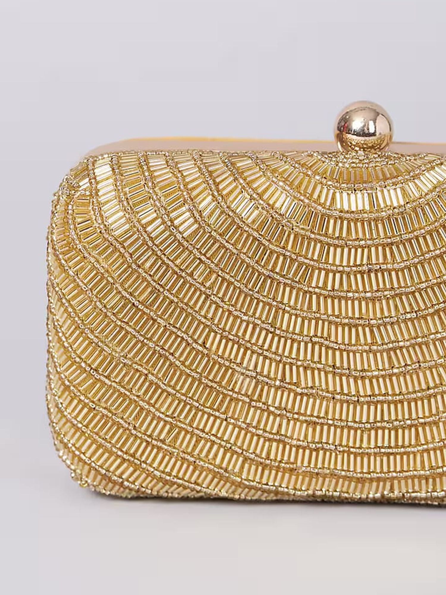 Gold beaded clutch bag by aclutchstory with intricate beadwork and a sleek design for elegant evening wear.
