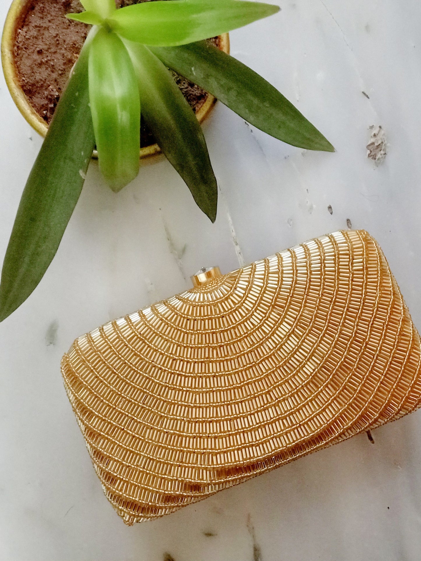 Gold Cleopatra clutch by Masoom Minawala featuring intricate details and a luxurious design, perfect for elegant occasions.