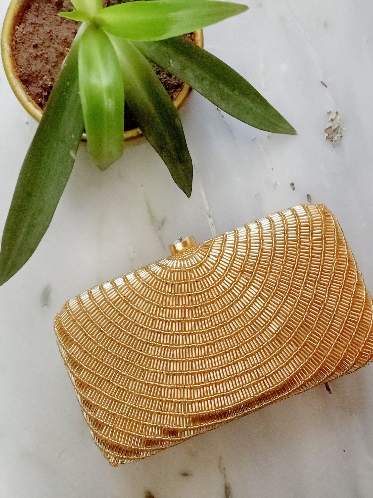 Gold Cleopatra clutch by Masoom Minawala featuring intricate details and a luxurious design, perfect for elegant occasions.