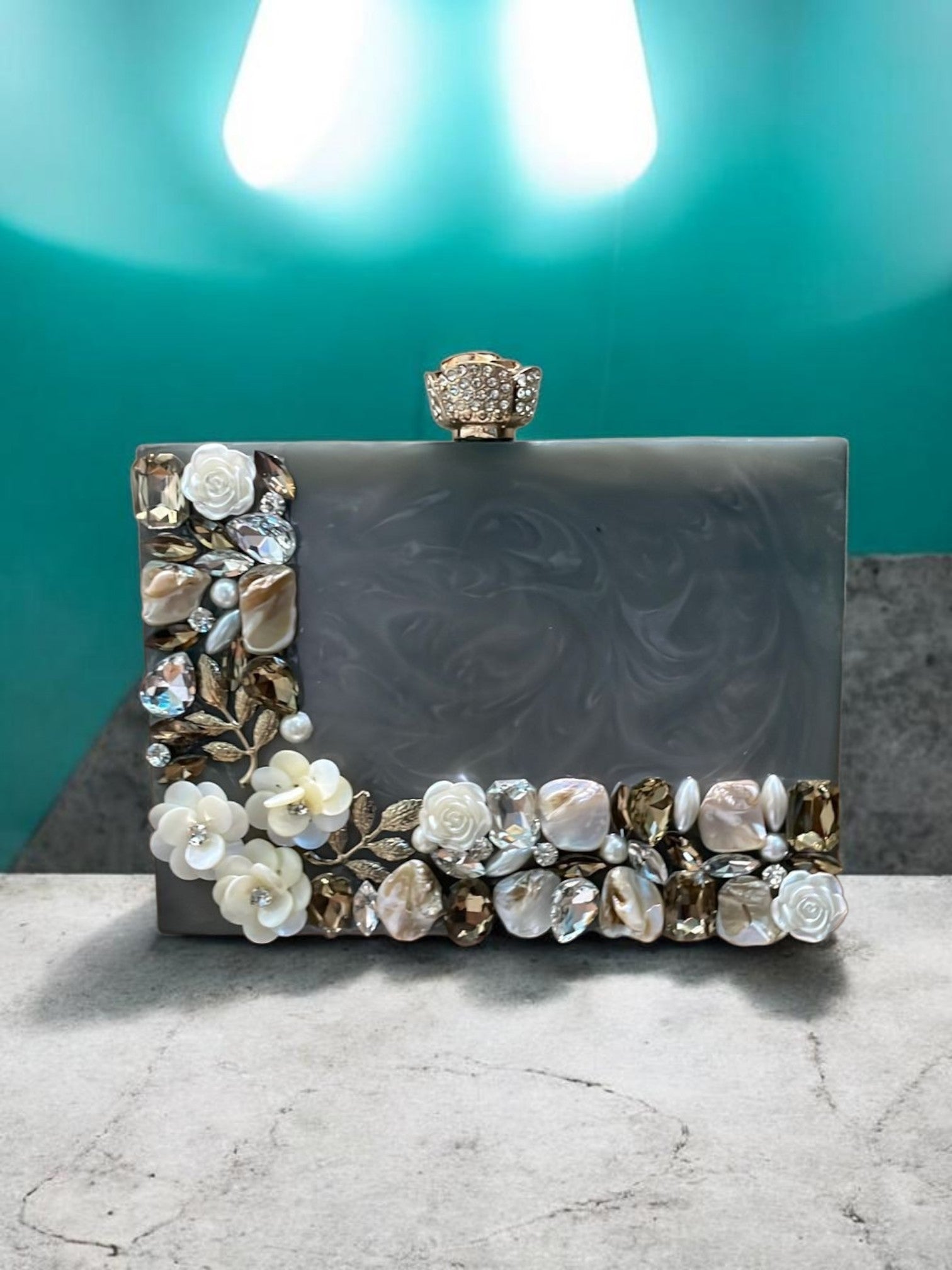 Grey Aura Resin clutch by aclutchstory, showcasing a stylish grey evening bag with stone work on the sides. 