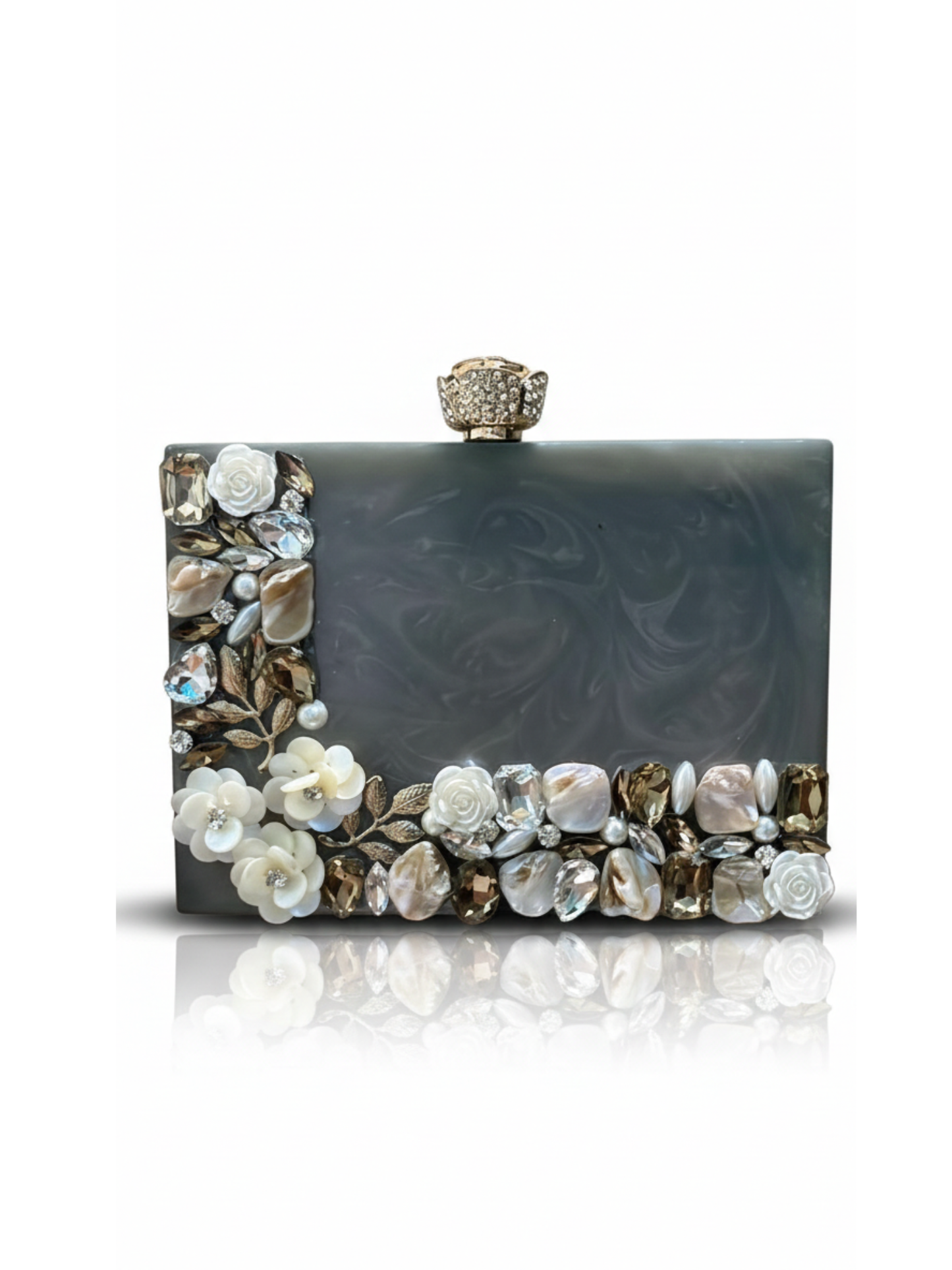Grey Aura Resin Clutch with elegant grey base and Rhinestones work on the sides. Comes with a beautiful diamond studded Rose knob. 