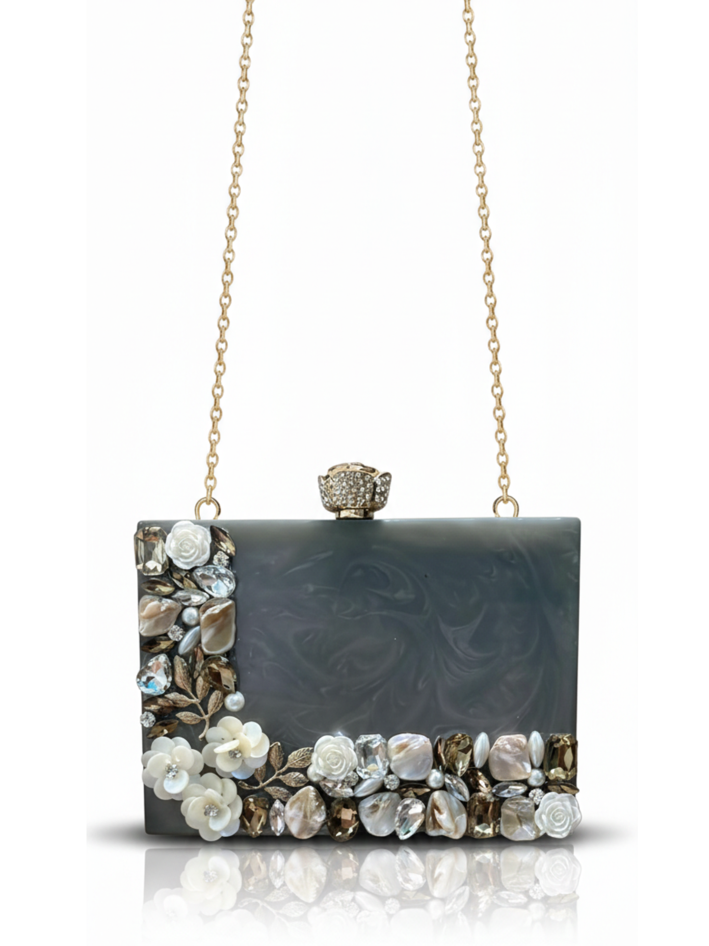 Grey Aura Resin Clutch with elegant grey base and Rhinestones work on the sides. Comes with a beautiful diamond studded Rose knob and a long sling chain.