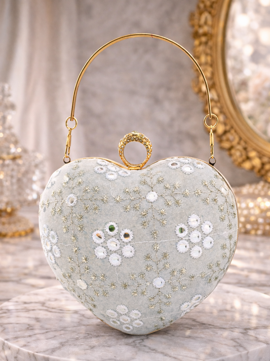 Ivory heart-shaped clutch purse with gold clasp from aclutchstory, featuring elegant design and compact size for evening occasions.