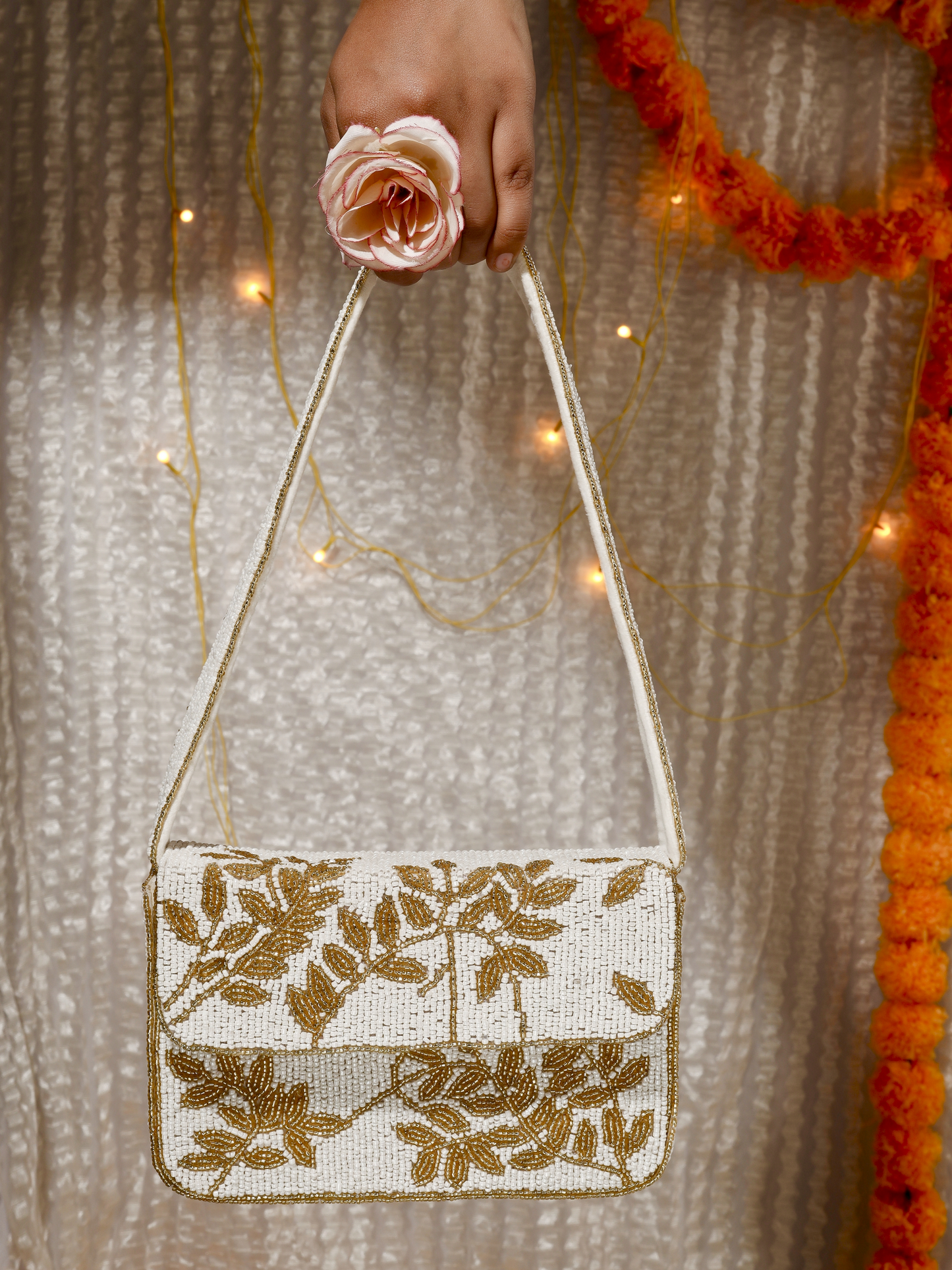Ivory and gold gleam clutch purse with elegant design and metallic accents, perfect for evening occasions.