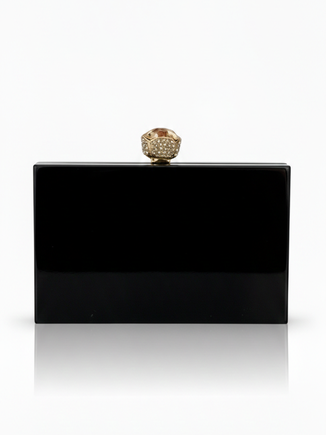 Black Midnight Aura clutch bag by aclutchstory featuring a sleek, elegant design with a textured finish and silver clasp detail.
