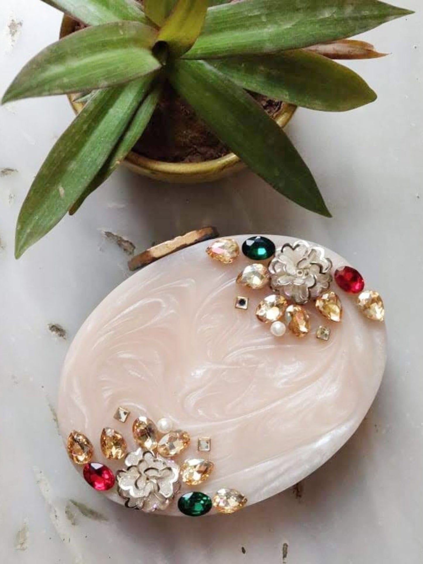 Oval agate resin clutch by aclutchstory with smooth polished surface and elegant design, perfect for evening occasions.