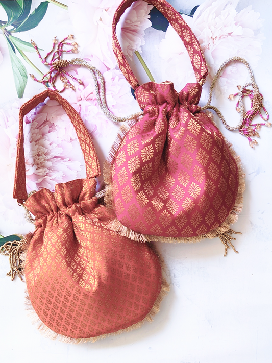 Set of 4 Banarasi Potlis with intricate gold and colorful embroidery, traditional Indian clutch bags for festive occasions