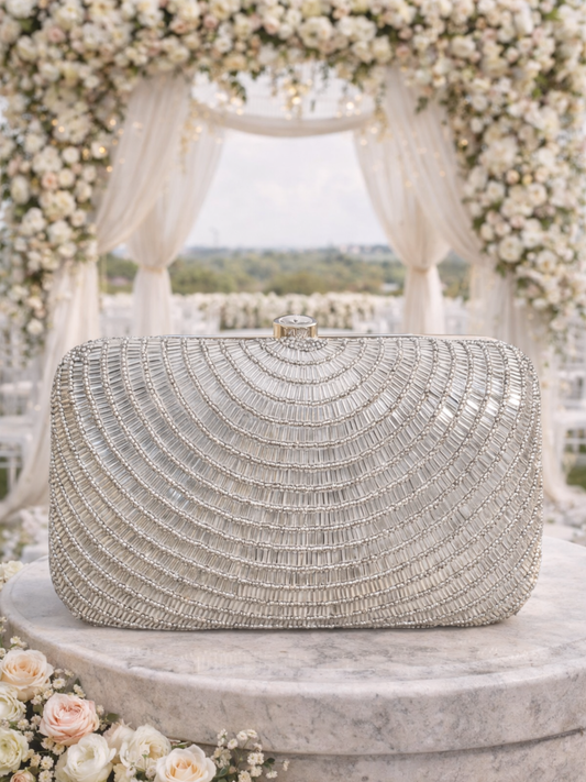 Silver Cleopatra clutch bag by Shaheen Bhatt featuring a sleek design with elegant embellishments.