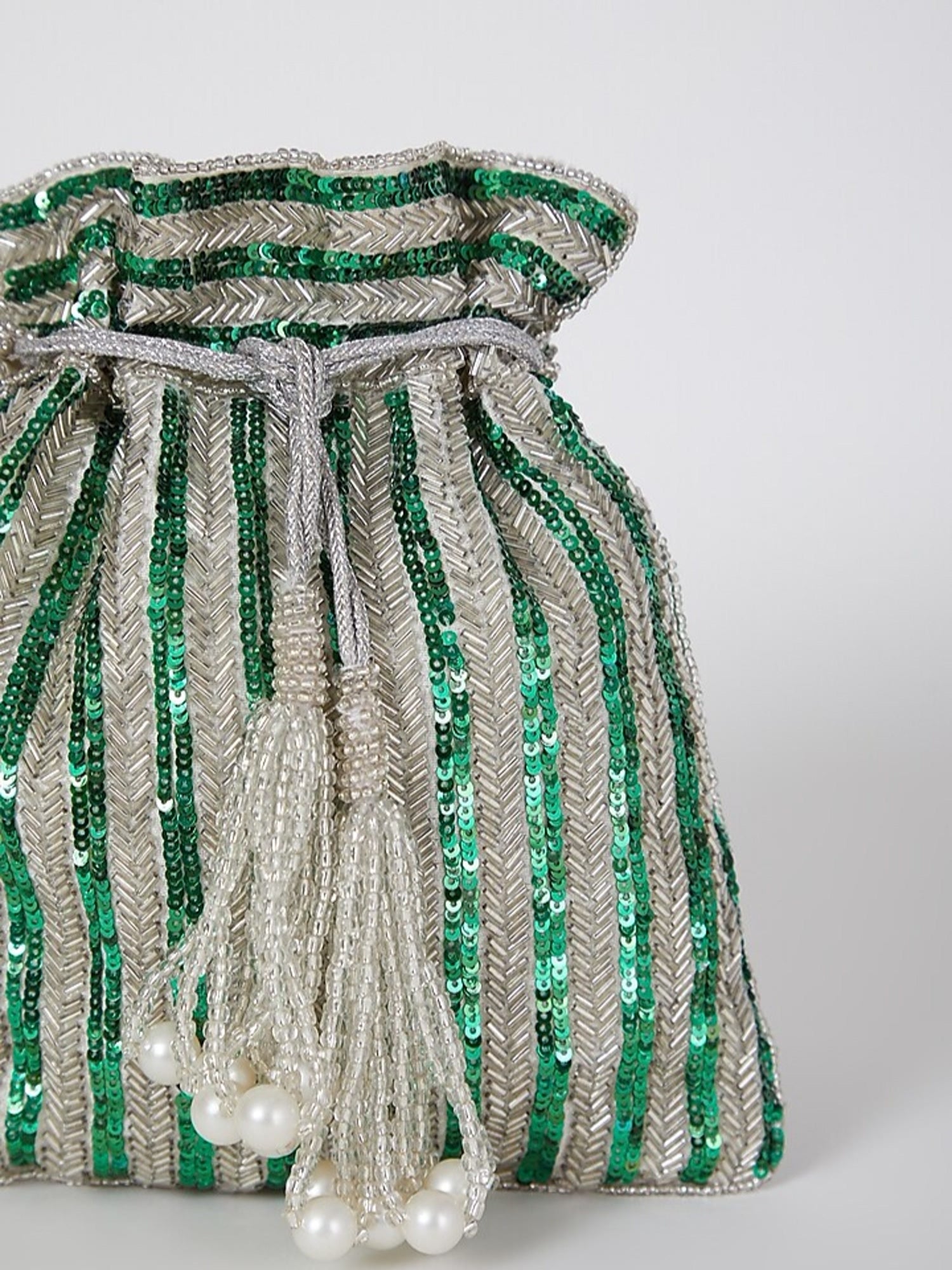 Green sequined hand-embroidered potli bag with intricate detailing, perfect for festive occasions and traditional events.