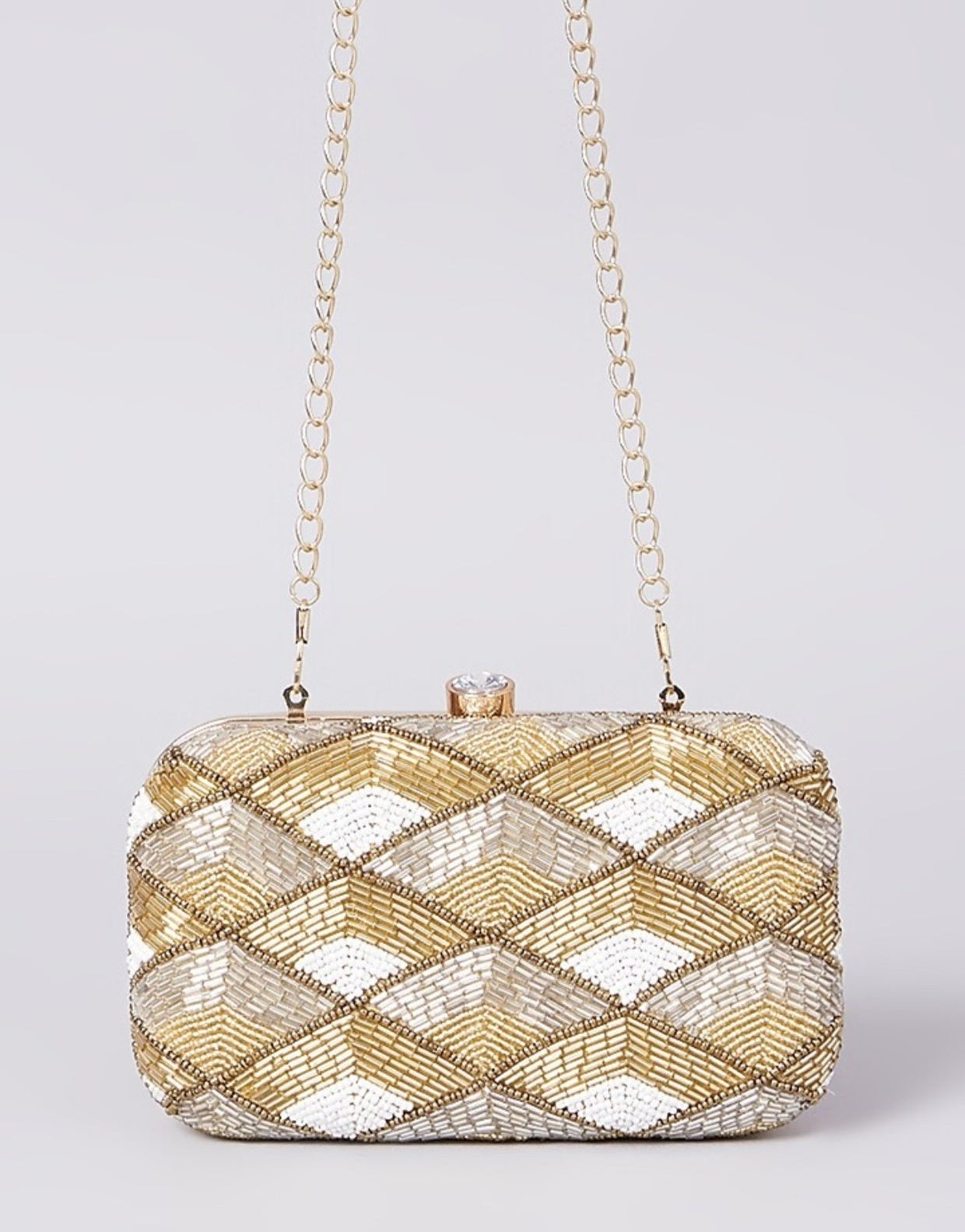 Tricolored hand-embroidered clutch bag with intricate embroidery, featuring vibrant colors and a sleek design by aclutchstory.