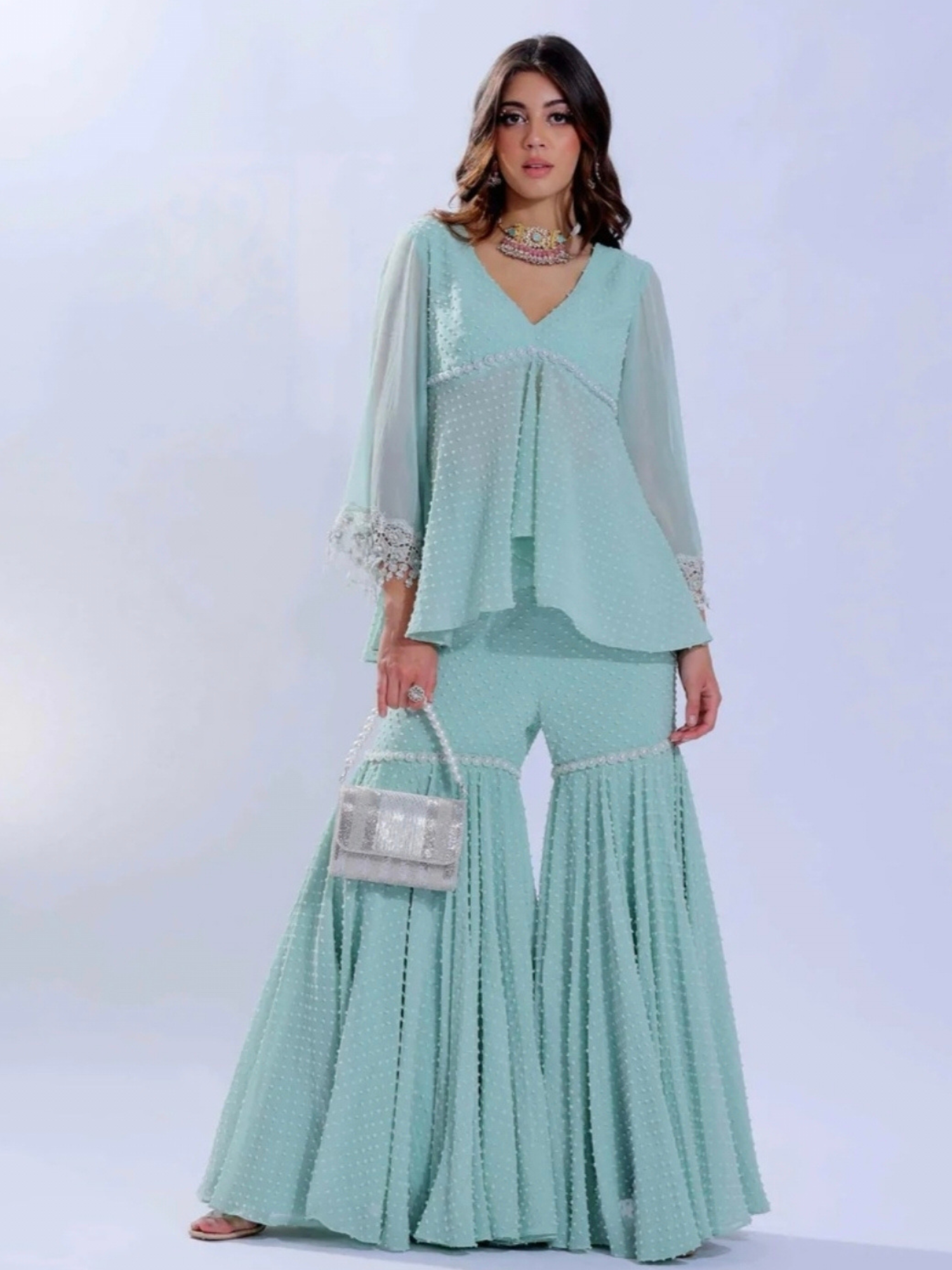 Silver beaded flapover clutch by aclutchstory showcasing intricate beadwork and elegant design.