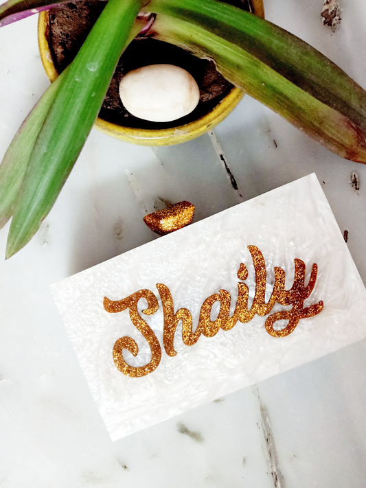 White glitter engraved customized clutch by aclutchstory featuring a sleek design and personalized engraving for elegant occasions.