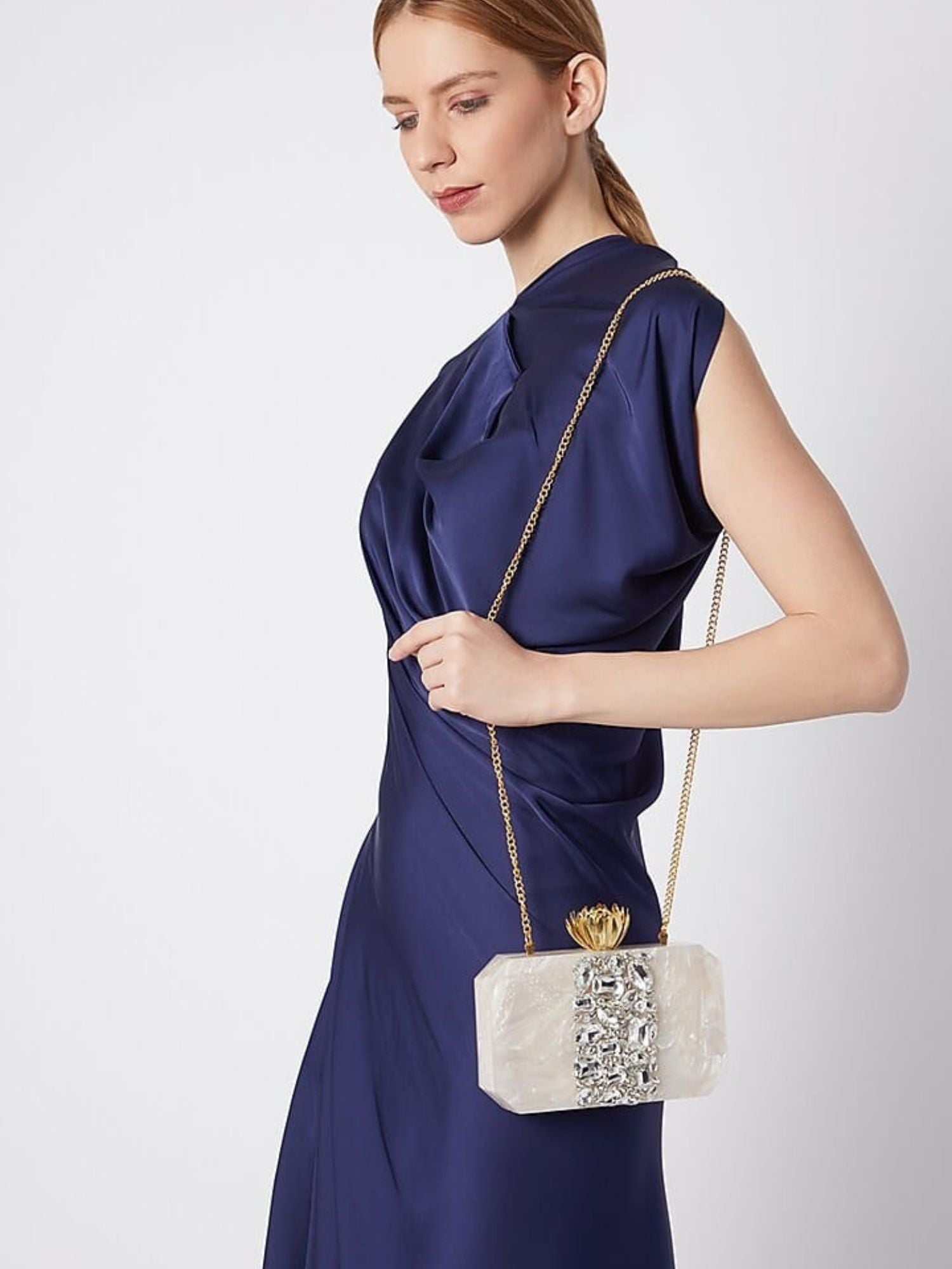 White Lotus Resin clutch bag with floral design from aclutchstory, featuring a sleek rectangular shape and smooth finish.
