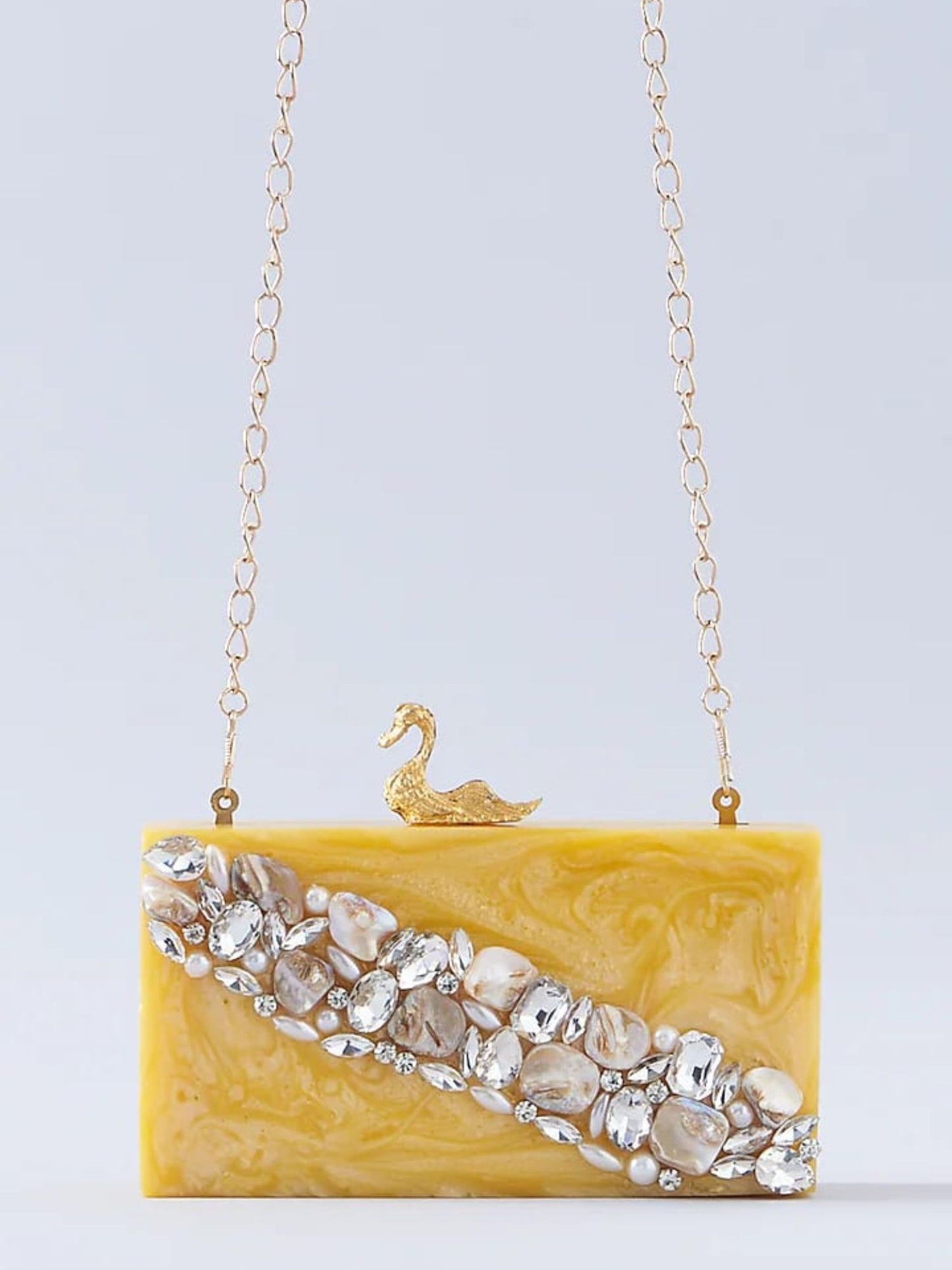 Swan-shaped resin clutch bag with a glossy finish, designed by aclutchstory, featuring a sleek and elegant accessory for evening wear.