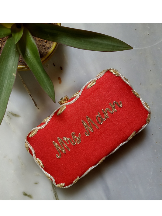 Red Dabka leaf clutch bag with intricate embroidery, custom design from aclutchstory showcasing detailed craftsmanship and vibrant color.